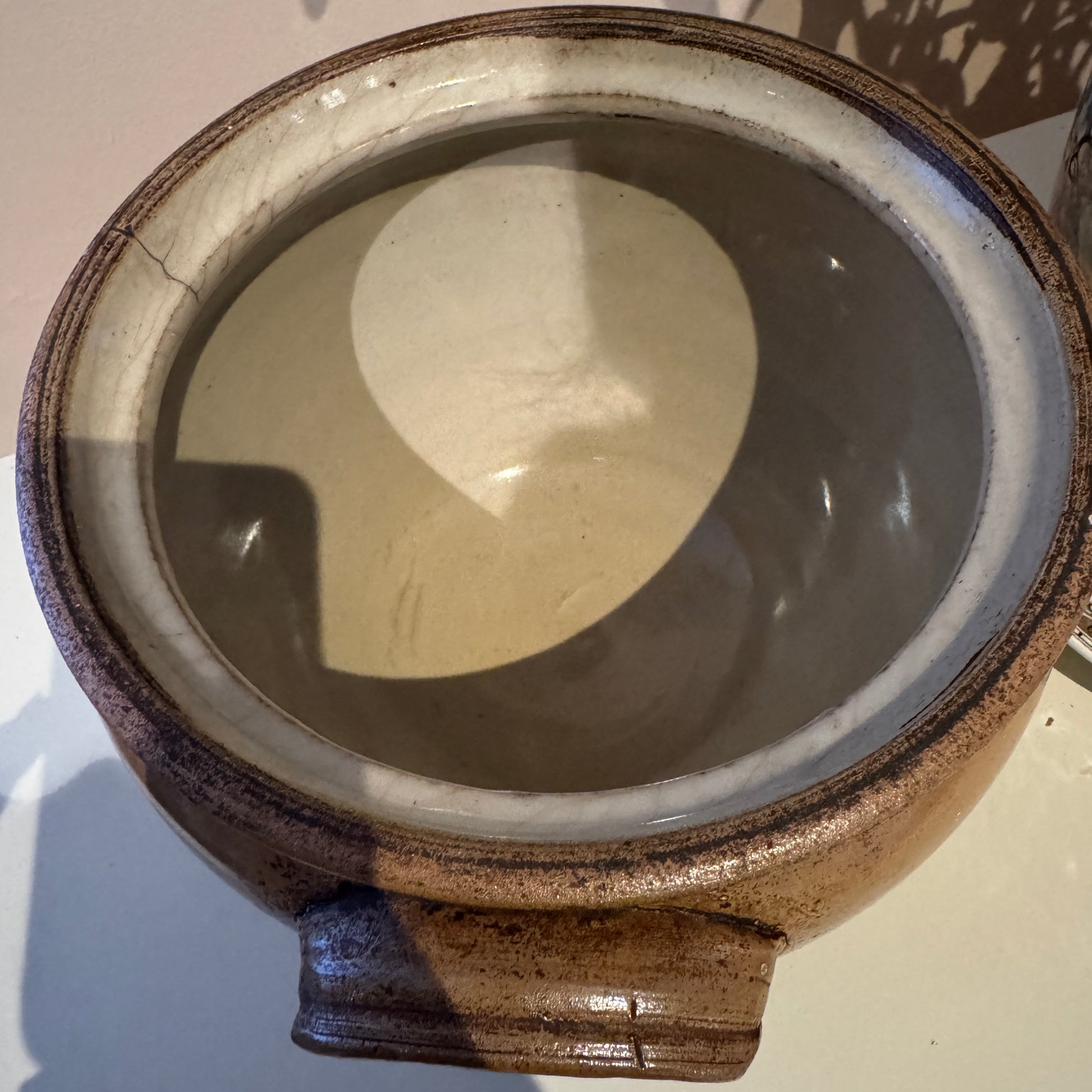 Ceramic pot with a textured surface on a light background