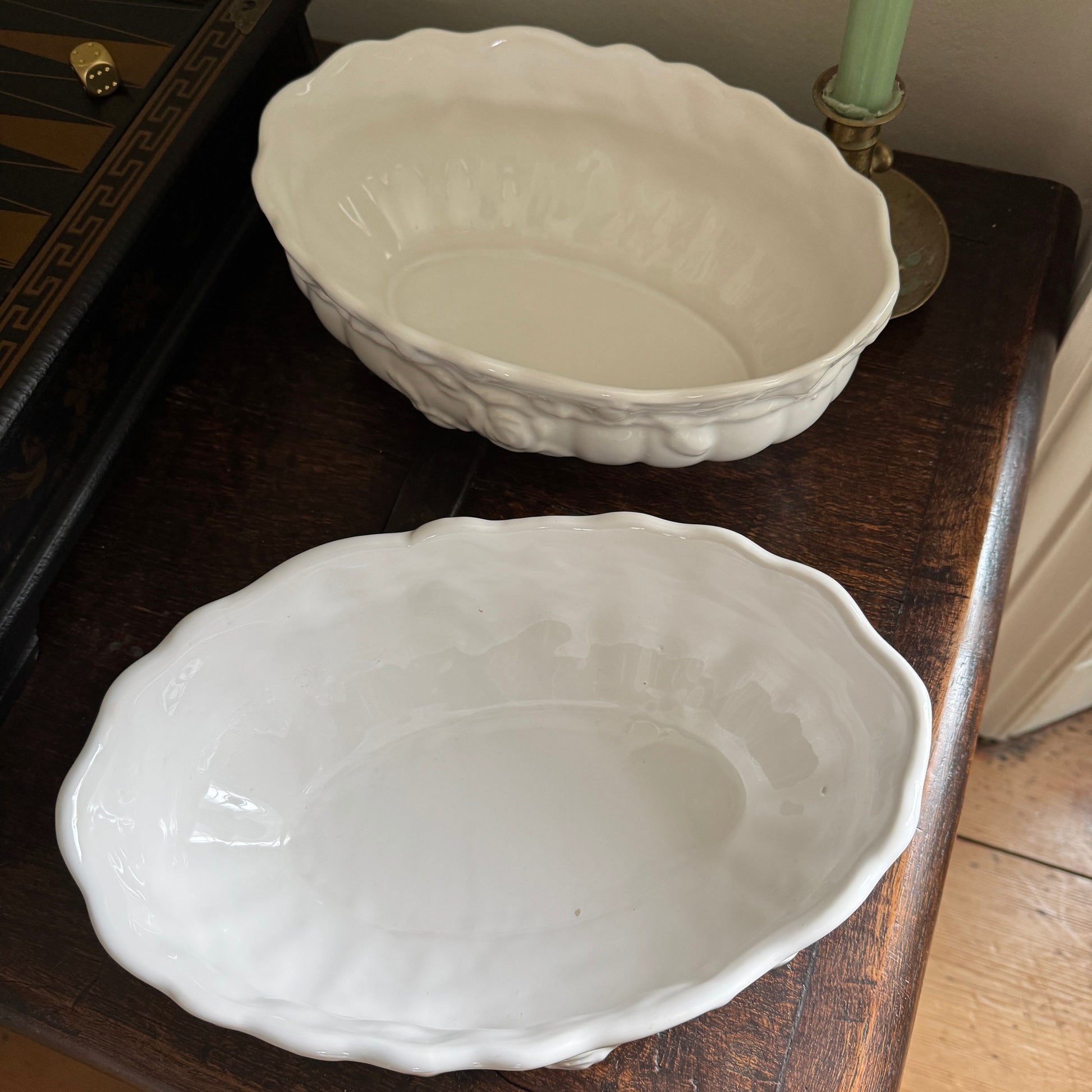 Two white ceramic bowls on a wooden surface.