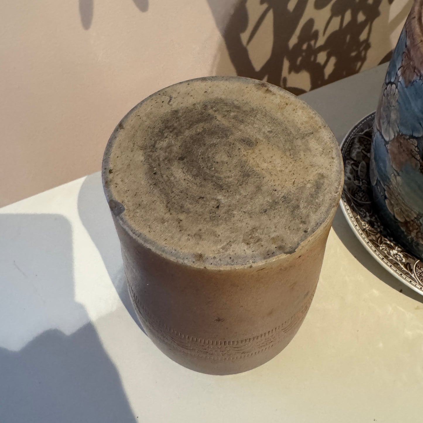 Clay pot on a white surface with a neutral background